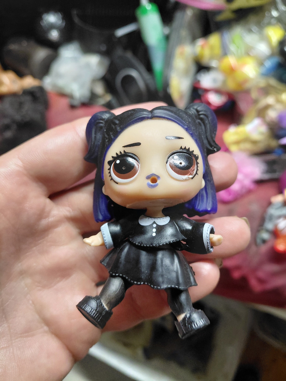 show the Dusk character doll from the L.O.L. Surprise! Furniture Cozy Zone set.